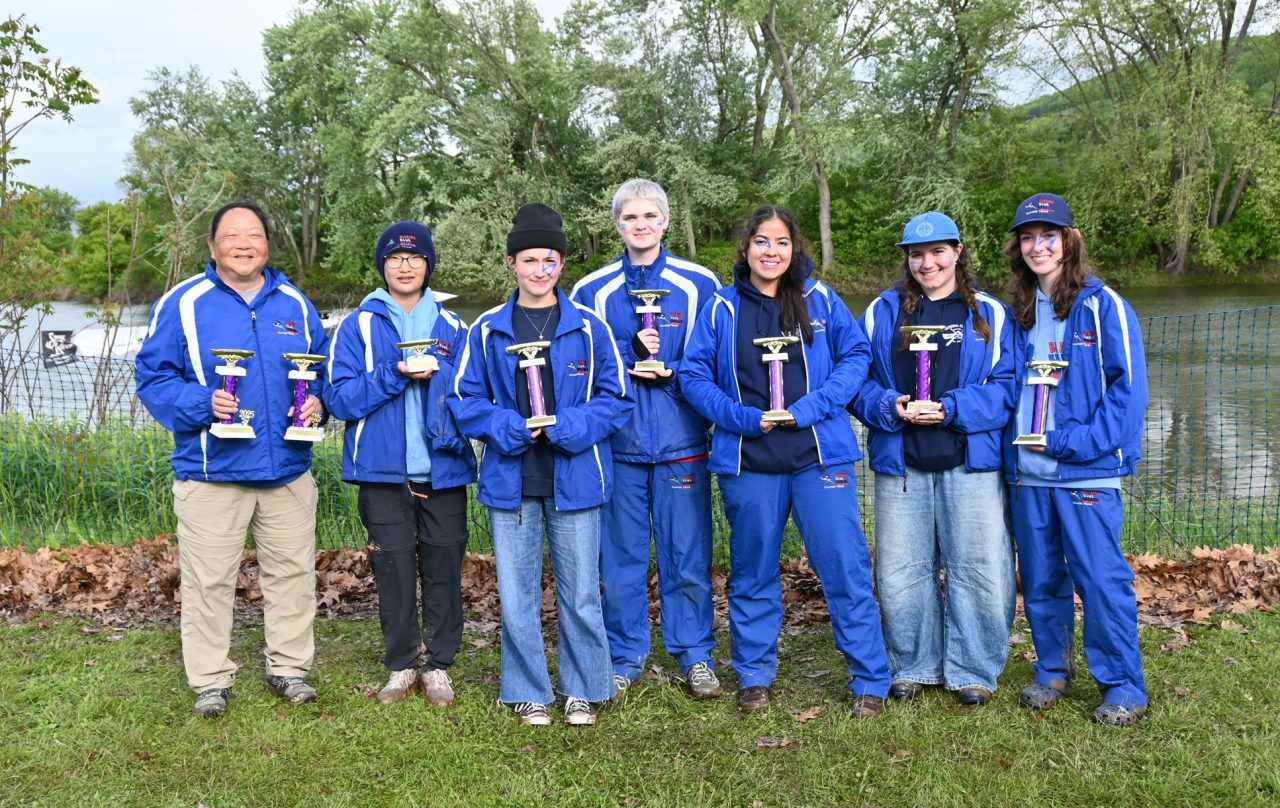 Girl Scout Blazing Blue Herons with their trophies, all smiles after the races
