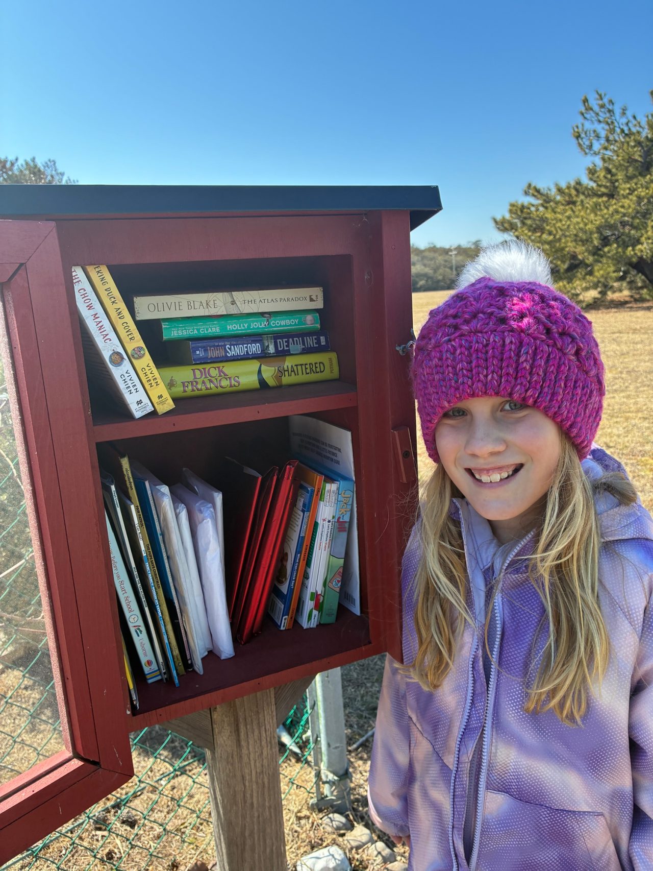 Girl Scout Junior stands next to one of the Little Free Libraries located on Joint Expeditionary Base Little Creek-Fort Story in Virginia Beach