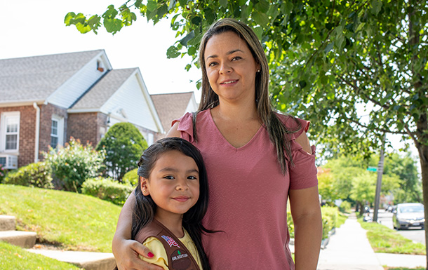 Parent standing with her Girl Scout Brownie.