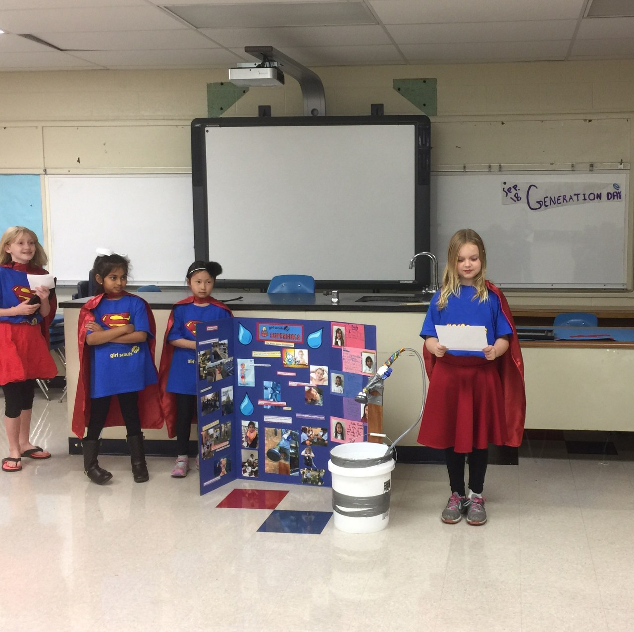 Supergirl Emery presents the team's water-saving showerhead prototype.